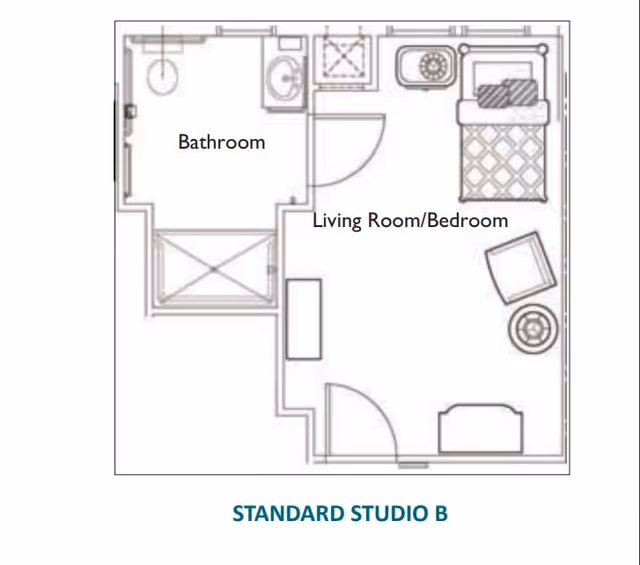 Floor plan layout of a standard studio apartment labeled Standard Studio B, showing a combined living room and bedroom area with a bed, chair, table, and a bathroom with a shower, sink, and toilet.