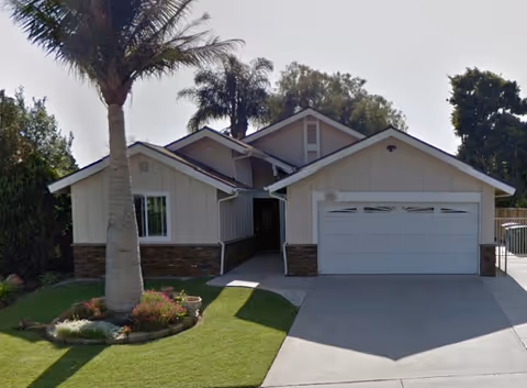 Front exterior of Sally Residential Care Home 3, a single-story house with a two-car garage.