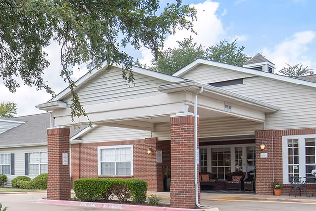 Front exterior of Brookdale Collin Oaks senior living facility with covered entry.