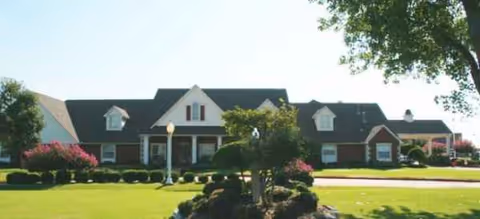 Front view of Magnolia Assisted Living Edmond building with a manicured lawn and shrubs