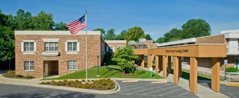 Exterior view of Calvert County Nursing Center with brick facade and flagpole