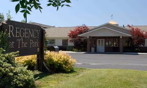 Front view of Regency at The Park nursing home with sign and entrance.