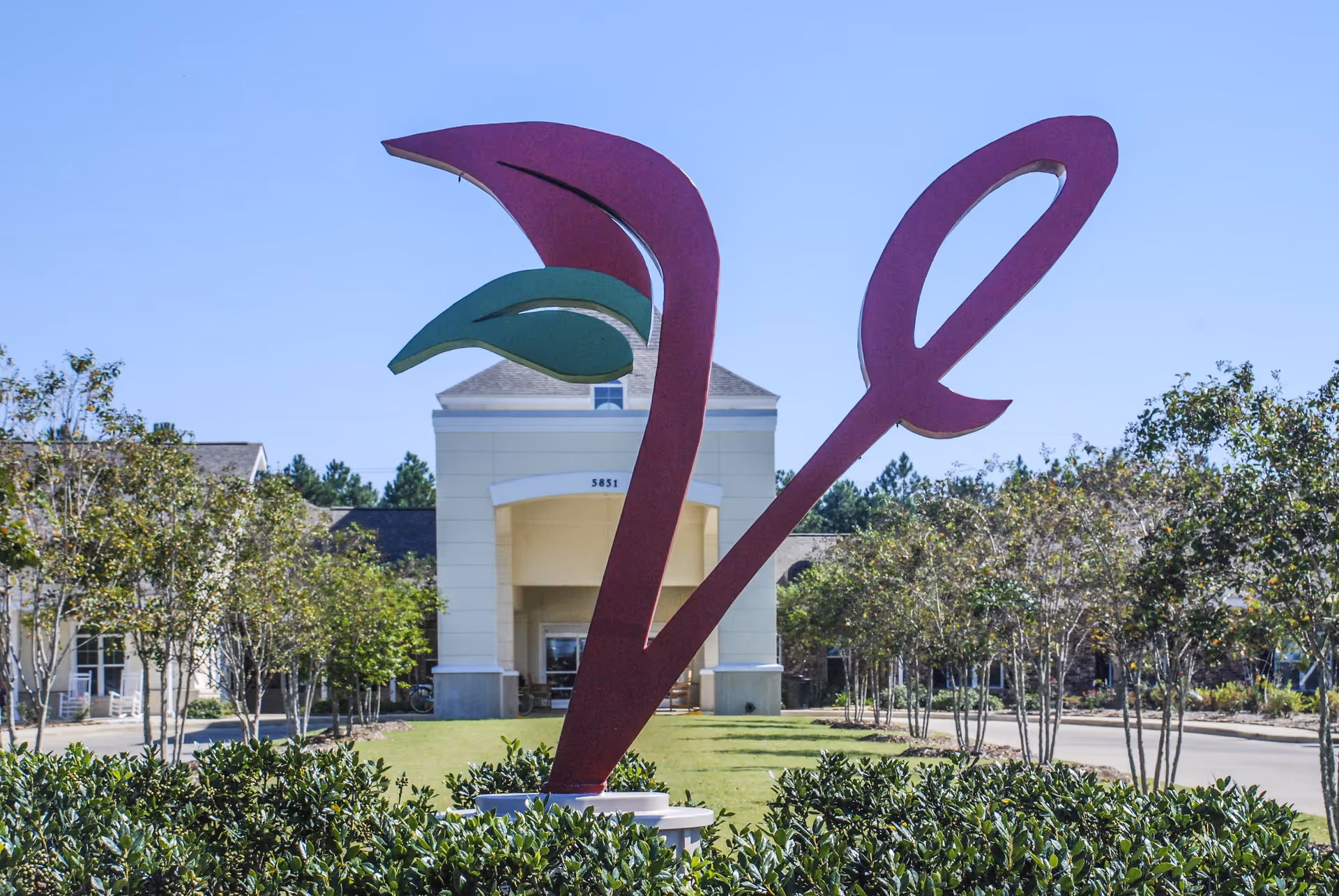 Large purple abstract sculpture in front of The Verandah Retirement Community entrance.