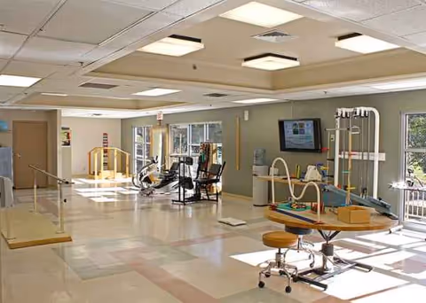 Interior rehabilitation gym at Oak Park Nursing and Rehabilitation Center with various therapy equipment.