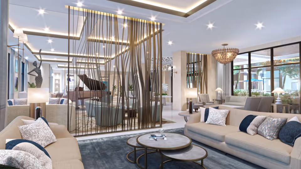 Spacious modern lounge with sofas, round coffee tables, decorative metal partition, a grand piano and large windows to an outdoor courtyard.