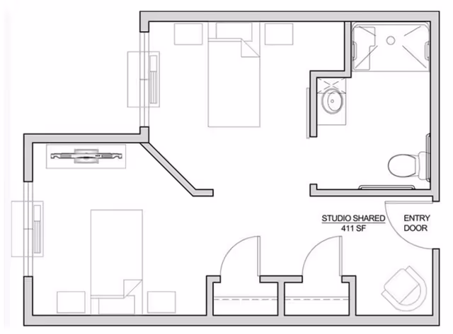 Architectural floor plan of a shared studio apartment at Fieldstone Memory Care Marysville, showing a layout with two beds, a bathroom with a shower, toilet, and sink, an entry door, closets, and a living area with seating and a TV.