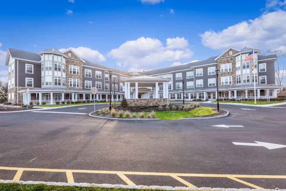 Exterior view of Sunrise of Mountain Lakes with a circular driveway and front entrance.