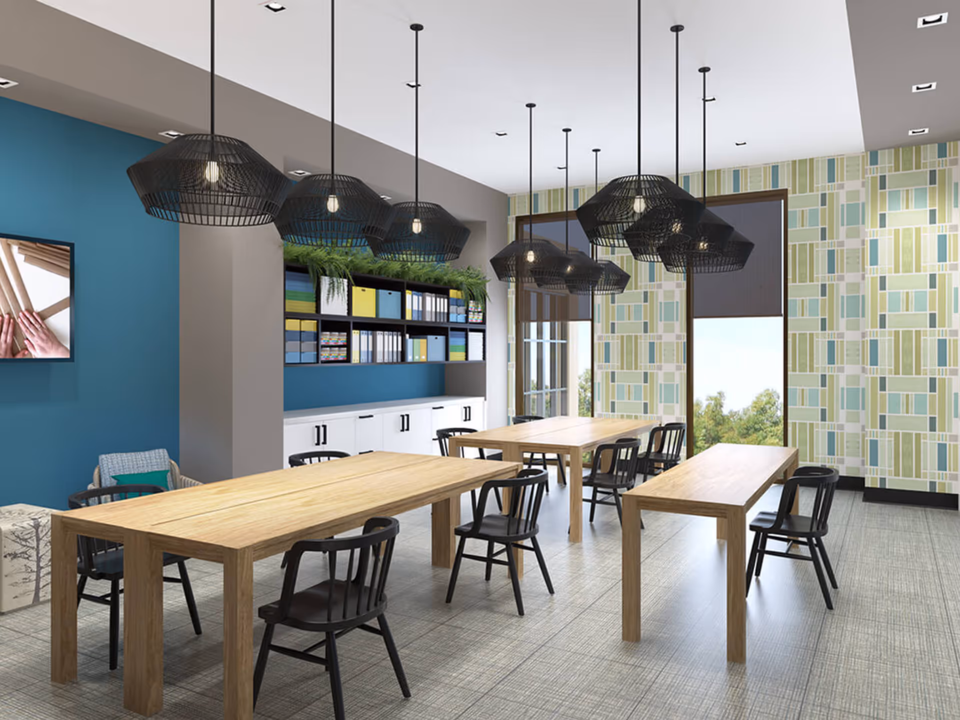 Modern communal dining room with long wooden tables, black chairs, hanging pendant lights, shelving and large windows.