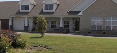 Brookdale McPherson exterior building with lawn, driveway, and front entryway.
