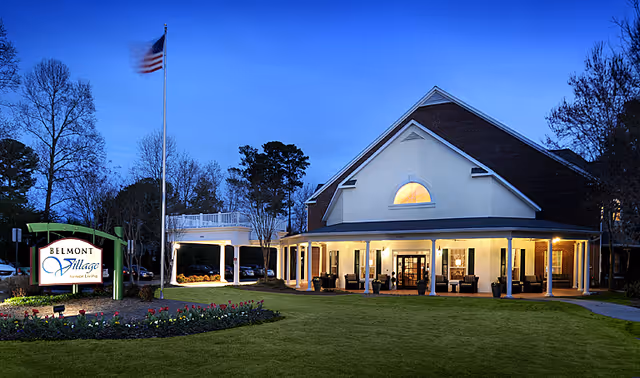 Exterior view of Belmont Village Buckhead facility with illuminated entrance and manicured lawn