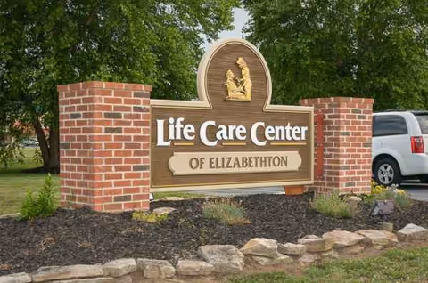 Life Care Center of Elizabethton sign with brick pillars and landscaping.