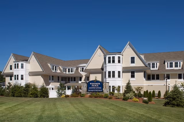 Wide view of Windsor Place of Wilmington exterior with manicured lawn.