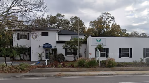 White, single-story Angels Senior Living at Palma Ceia exterior with landscaping and signage.