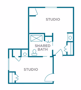 Architectural floor plan showing two studio apartments sharing a common bathroom. Each studio has its own entrance and closet space, with the shared bath located centrally between them.