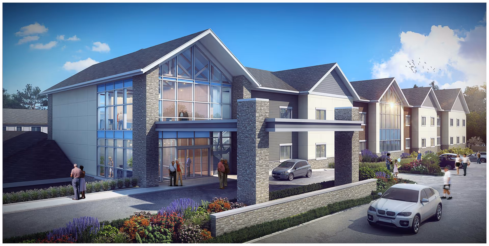 Exterior view of a modern senior living facility building with large glass windows, stone pillars, and a covered entrance. Several people are walking and standing near the entrance and parking area, with cars parked along the driveway. The sky is clear with a few clouds and birds flying.
