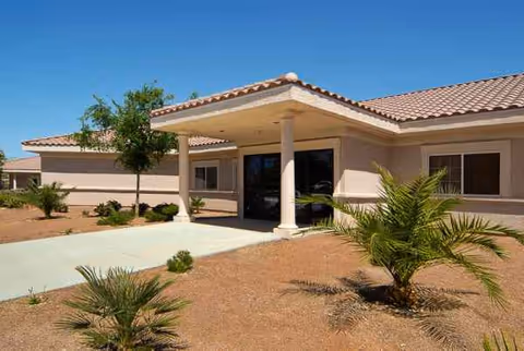 Entrance of Life Care Center of South Las Vegas with a covered porte-cochere and desert landscaping.