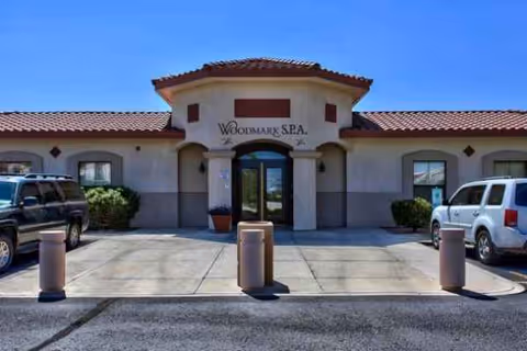 Front view of The Woodmark at Sun City entrance with parked cars.