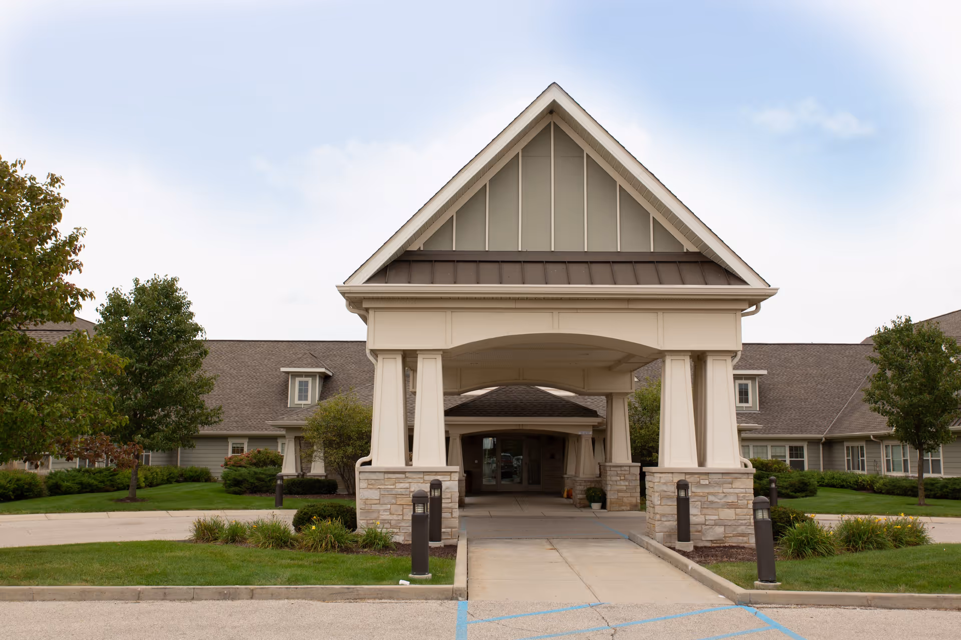 Covered entrance and porte-cochère of a single-story health services building with landscaped grounds.