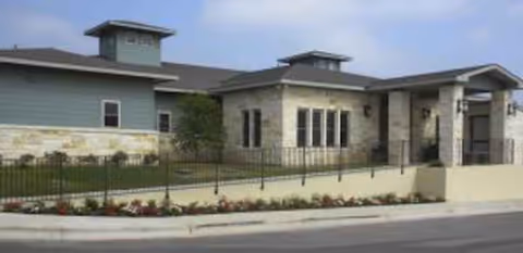 Exterior view of Sodalis at Dripping Springs with stone facade and landscaped entrance.