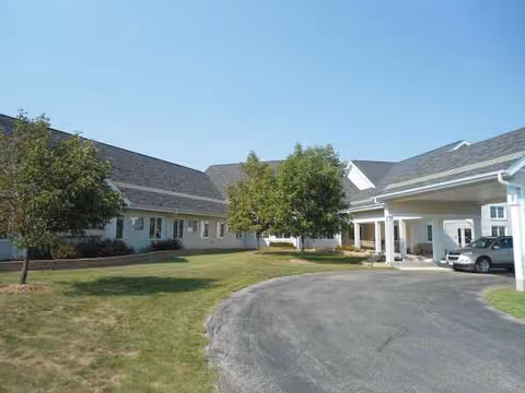 Exterior of Hubbard Care Center, a single-story building with a circular driveway and trees.