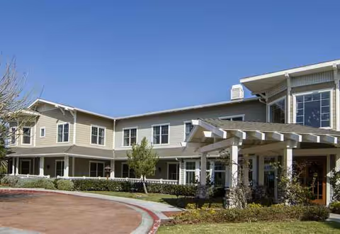 Sunrise at Bonita senior living facility exterior with entrance canopy and landscaped grounds.