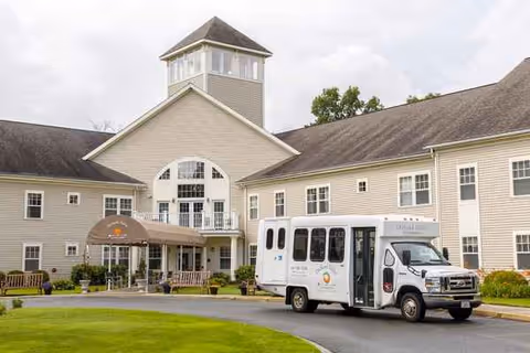 Exterior view of Benchmark at Orchard Valley with a shuttle bus at the entrance.