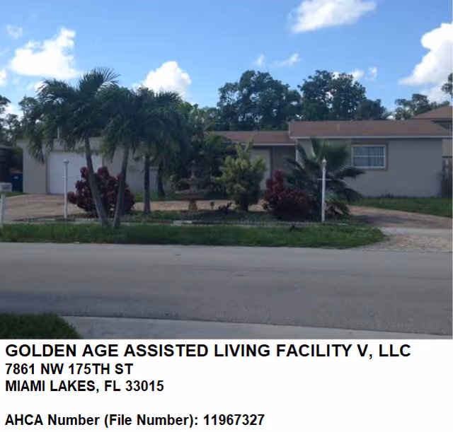 Single-story assisted living facility building with palm trees, a fountain and a driveway under a blue sky.