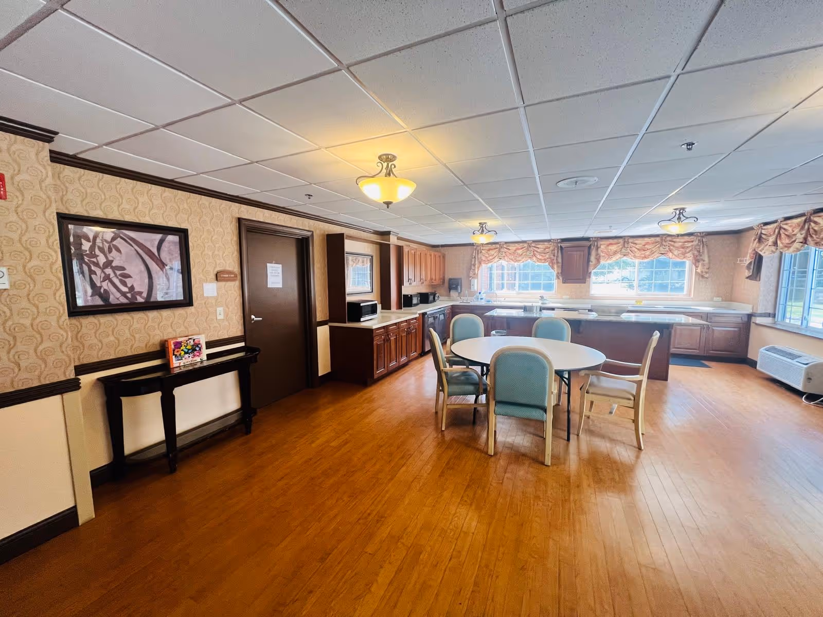 A spacious kitchen area with a dining table and modern cabinetry.