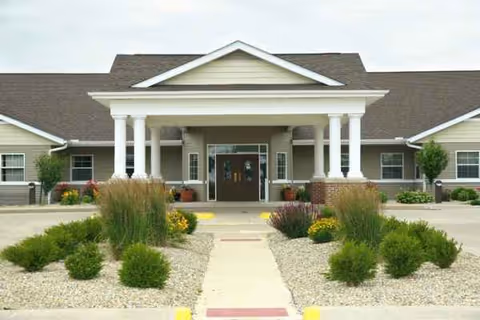 Front exterior view of The Pointe at Pontiac with columns, entrance, and landscaped grounds.