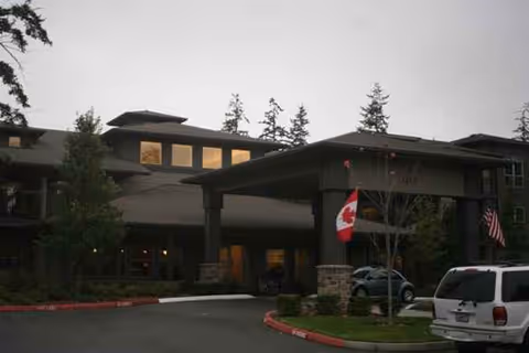Exterior view of Port Townsend Senior Living by Cogir with a covered entrance.