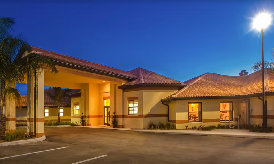 Dusk exterior view shows Best Care Senior Living at Punta Gorda entrance.