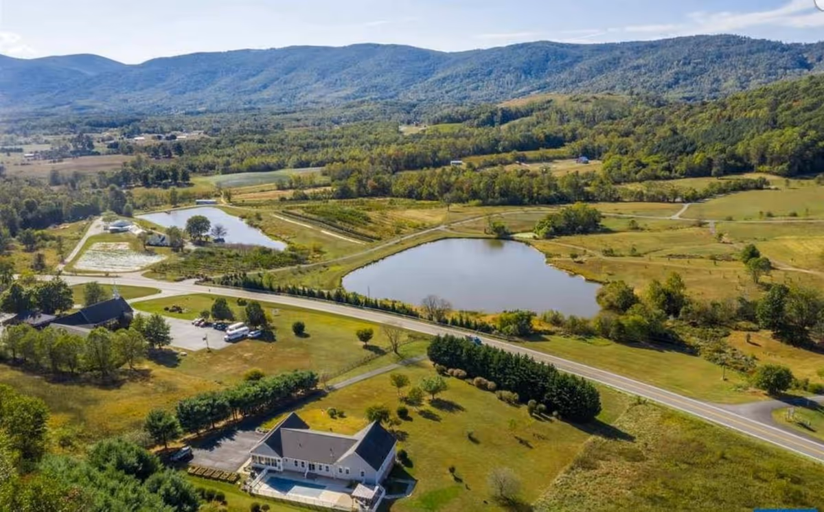 Aerial view of Acadia Care campus with buildings, ponds, roads, and farmland.