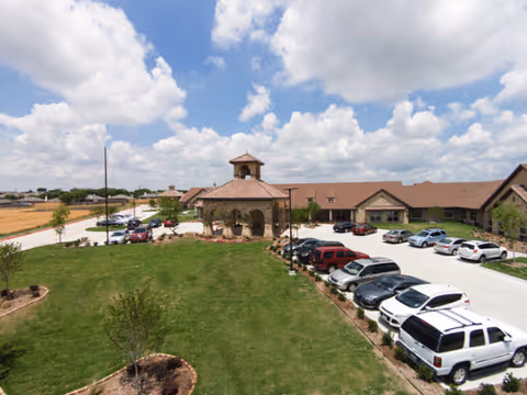 Front view of Belterra Health and Rehabilitation Center with parking lot and landscaped lawn.