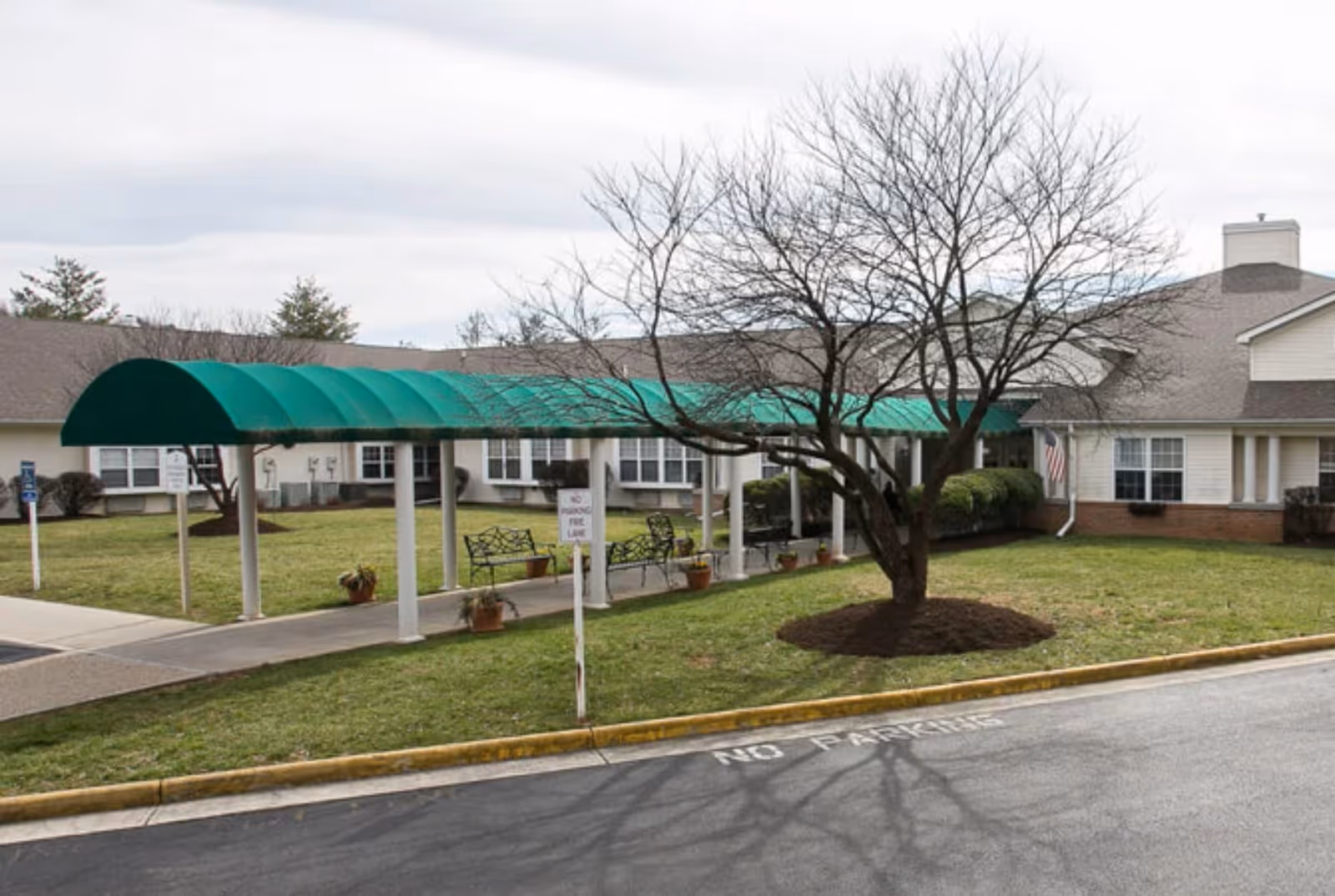 Exterior view of Cardinal Senior Living at Roanoke showing a green canopy walkway
