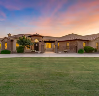 Arizona Assisted Living facility with brick exterior, gated entrance, and well-kept lawn.
