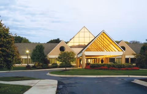 Front exterior of Shelby - An Optalis Health & Rehabilitation Center with glass entrance.