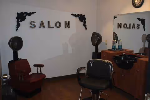 Interior hair salon with chairs, mirrors, and styling equipment in a care center.