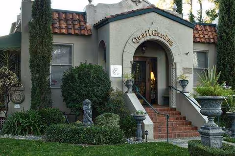 Front entrance of Quail Garden facility with arched doorway and steps.