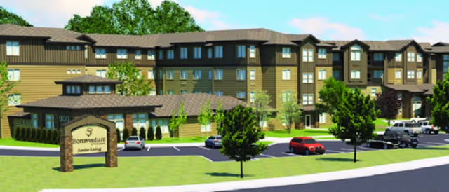 Exterior view of Bonaventure of Vancouver, a multi-story senior living facility with brown and beige siding, multiple windows, a parking lot with several cars, green trees, and a sign at the entrance that reads 'Bonaventure Senior Living'.