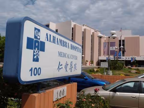 Exterior view of Alhambra Hospital Medical Center with a large entrance sign.