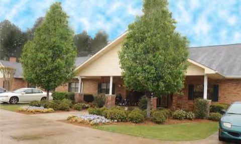 Front view of Ruston Nursing and Rehabilitation Center with entrance canopy and landscaped shrubs.