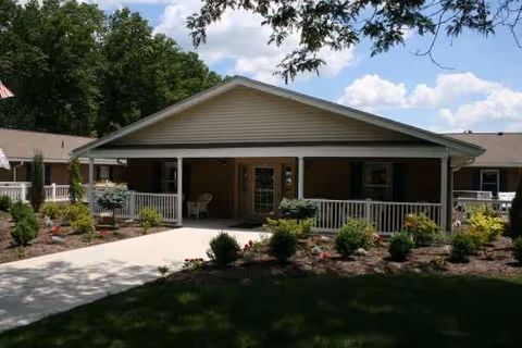 Front view of Altercare Alliance facility entrance with landscaped walkway and covered porch.