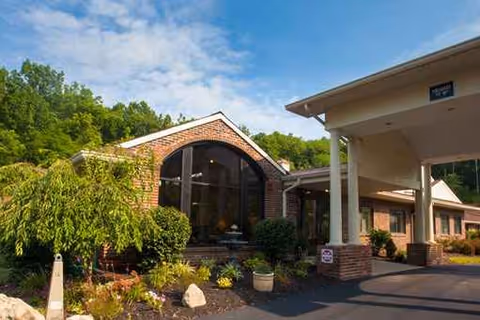Front view of Loveland Health Care facility with landscaped entrance and driveway.