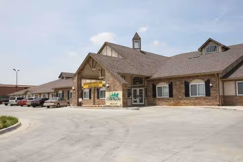 Exterior view of Village at Oakwood senior living facility with a front entrance.