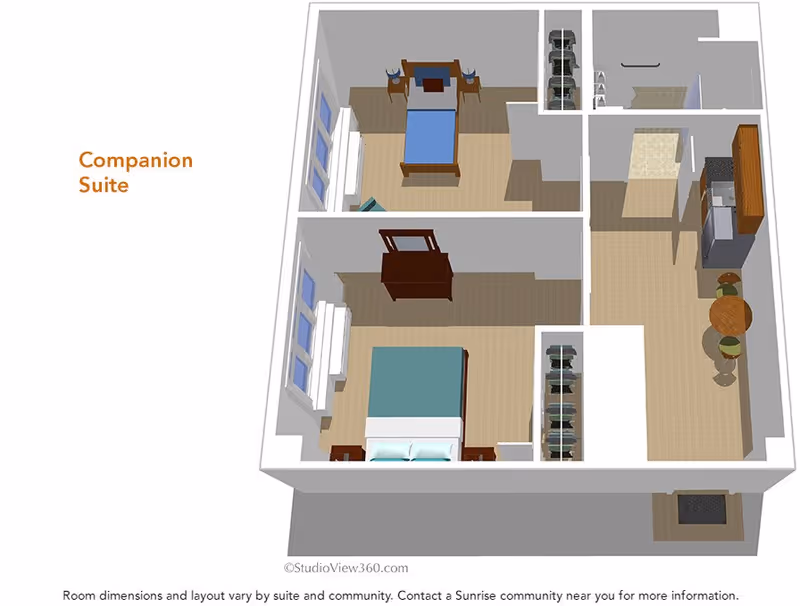 3D floor plan of a companion suite showing two bedrooms, a kitchen area with a round table and two chairs, closets, and an entryway. The larger bedroom has a double bed and dresser, while the smaller bedroom has a single bed and desk with two chairs.