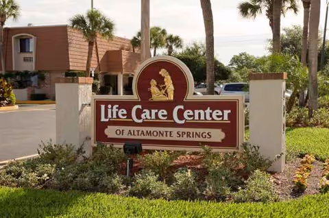 Life Care Center of Altamonte Springs sign at facility entrance with palms.