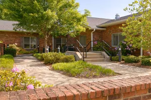 Exterior of Life Care Center of Hendersonville with brick walkway and landscaped entry