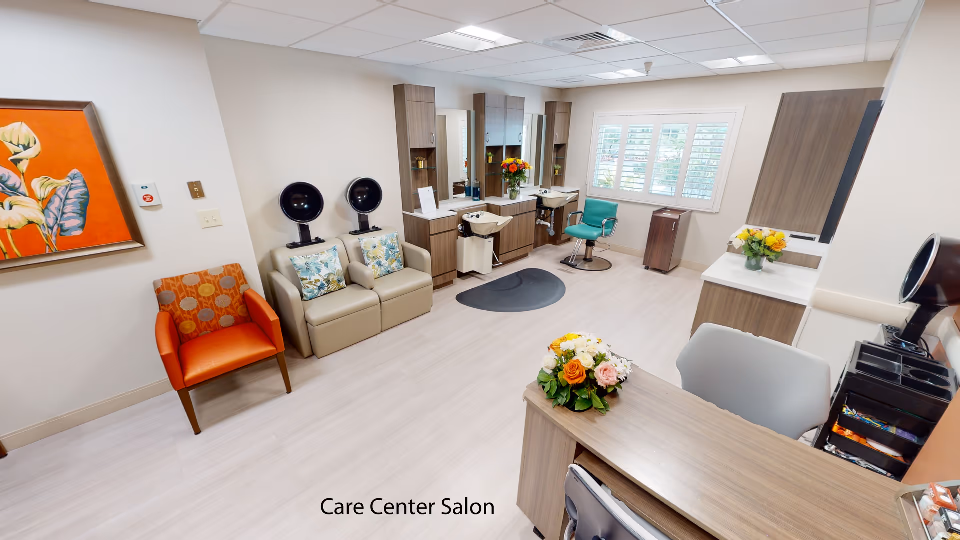 A bright care center salon with styling stations, chairs, sinks, and floral arrangements.