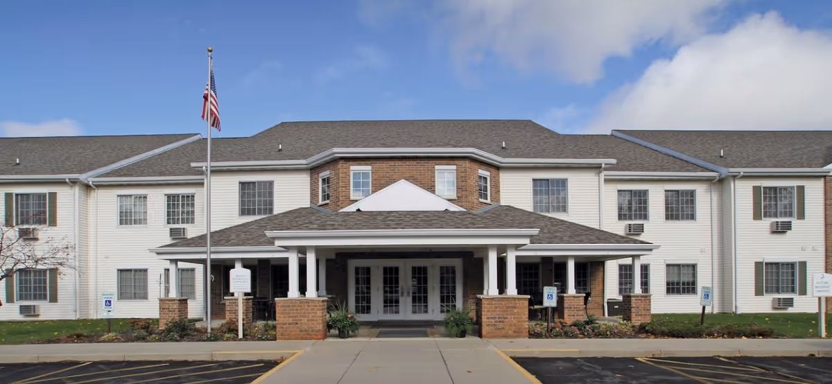 Exterior view of Dimensions Living Appleton with a covered entrance and flagpole.