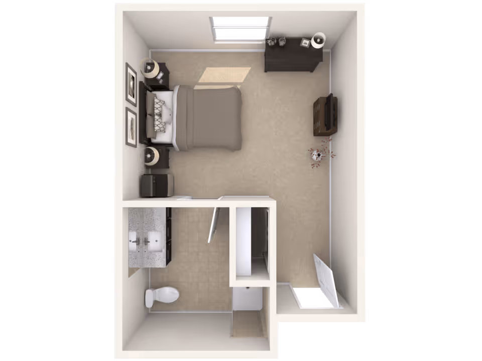 Top-down view of a senior living facility room layout showing a bedroom with a bed, two nightstands with lamps, a dresser, a TV on a stand, and a small closet. Attached is a bathroom with a double sink vanity, toilet, and shower.